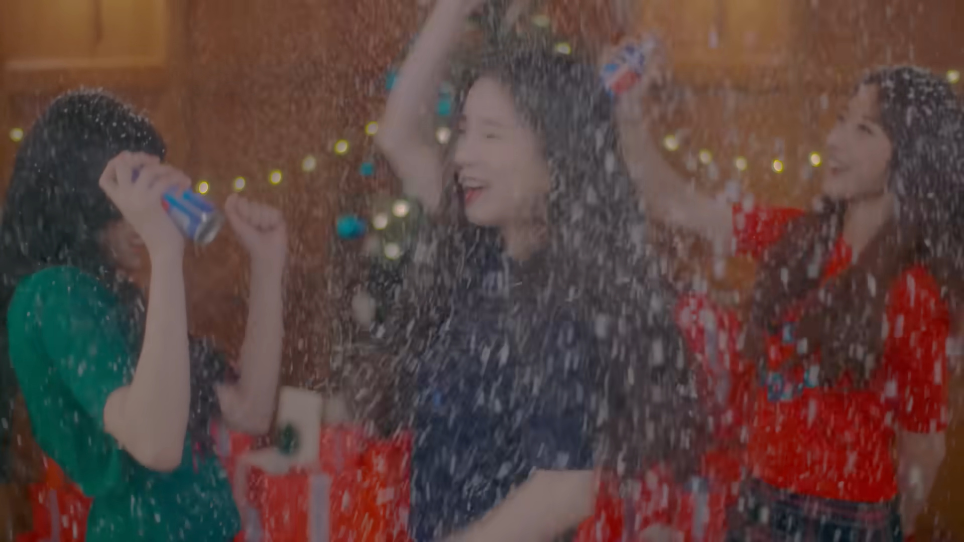 Hyunjin, Heejin, and Haseul spraying fake snow and dancing.